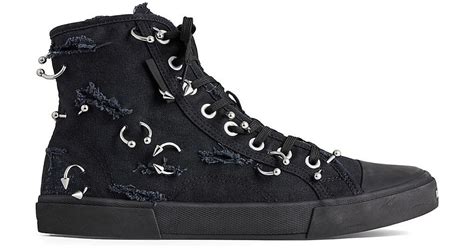 Paris high top sneaker with piercings .